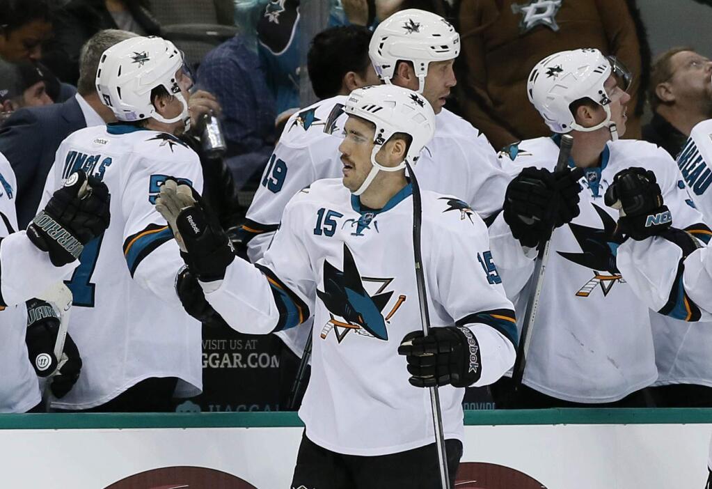 San Jose Sharks' James Sheppard (15) is congratulated by teammates after scoring against the Dallas Stars in the first period of a game, Saturday, Nov. 8, 2014, in Dallas. (AP Photo/Tony Gutierrez)