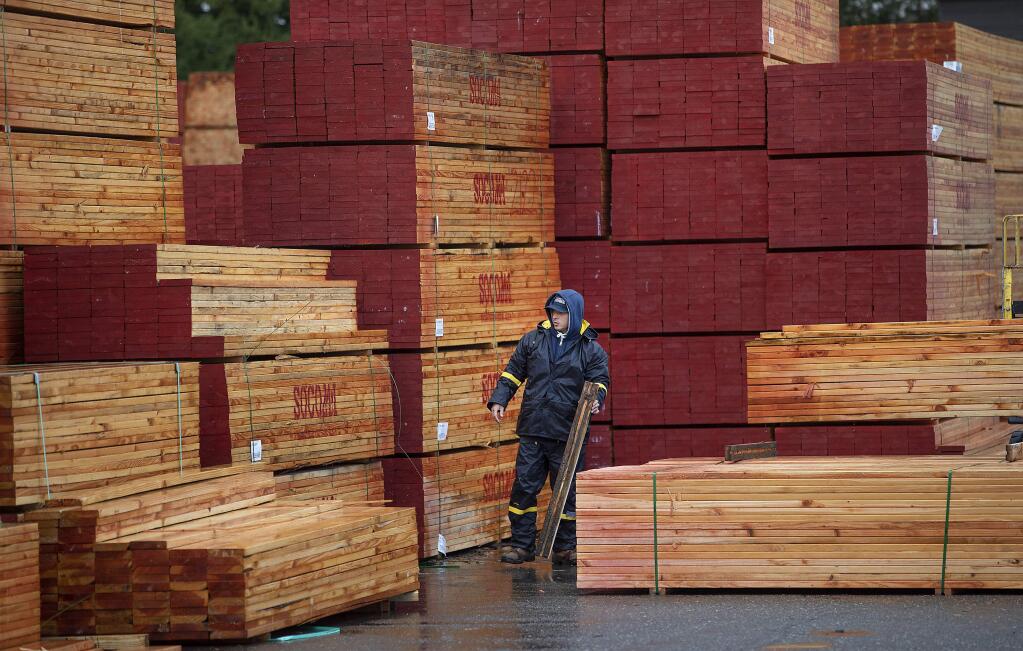A Mead Clark Lumber Co. employee prepares a load of lumber heading for the rebuild in Coffey Park in Santa Rosa. (photo by John Burgess/The Press Democrat)