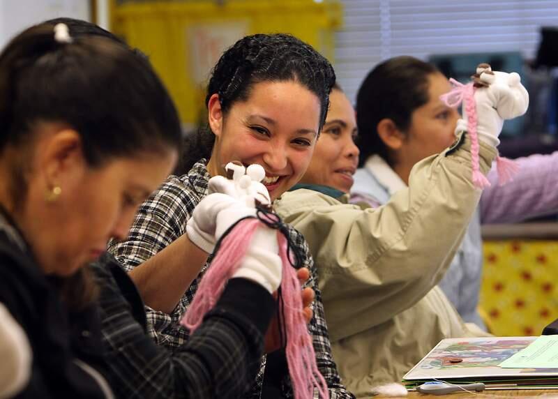 (File photo, left to right) Luz Maria Muro, Yuliana Nunez, and Juana Moreno practice using the sock puppets they created to make playtime an educational experience in their Avance parenting class at Kawana Elementary School in Santa Rosa on Tuesday, January 25, 2011. The program is overseen by Community Action Partnership of Sonoma County.