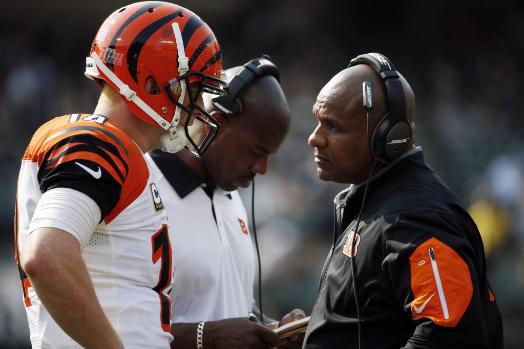 Cincinnati Bengals offensive coordinated Hue Jackson, right, talks to quarterback Andy Dalton during a game against the Oakland Raiders Sunday, Sept. 13, 2015. (AP Photo/Tony Avelar)