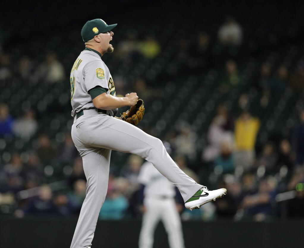 Oakland Athletics closing pitcher Blake Treinen reacts at the end of the 7-3 win over the Seattle Mariners in a baseball game, Monday, Sept. 24, 2018, in Seattle. (AP Photo/John Froschauer)