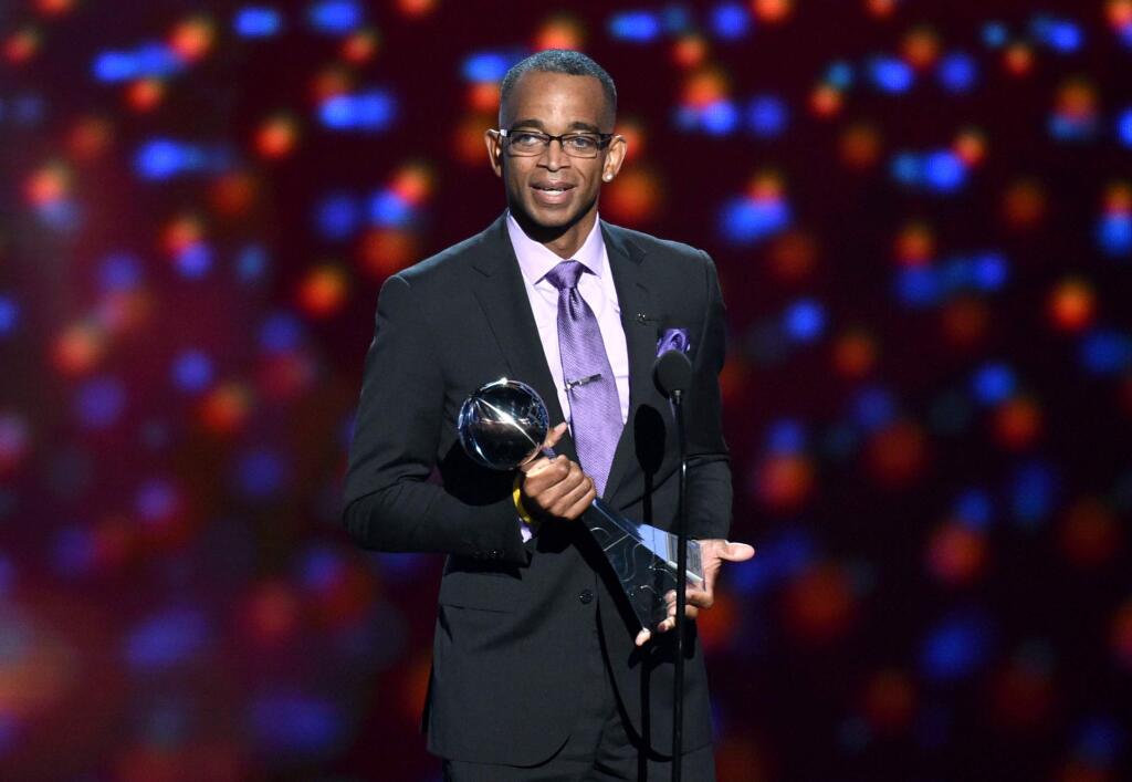 FILE - In a July 16, 2014 file photo, sportscaster Stuart Scott accepts the Jimmy V award for perseverance, at the ESPY Awards at the Nokia Theatre, in Los Angeles. Scott, the longtime 'SportsCenter' anchor and ESPN personality known for his known for his enthusiasm and ubiquity, died Sunday, Jan. 4, 2015 after a long fight with cancer. He was 49. (Photo by John Shearer/Invision/AP, File)