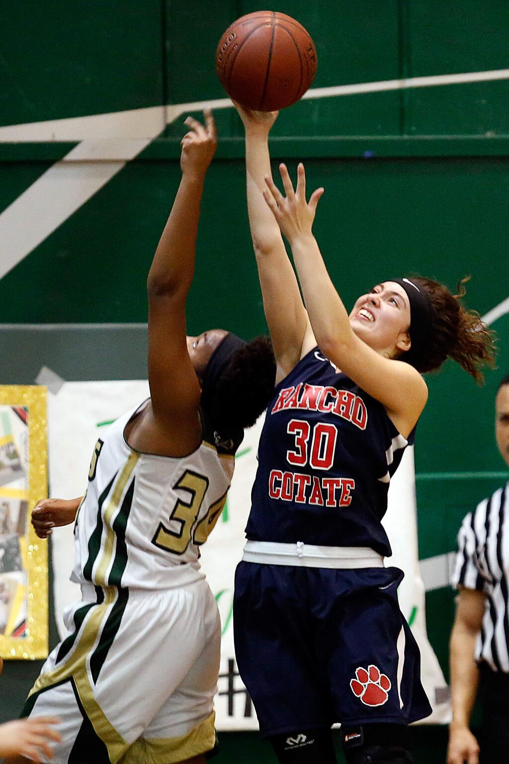 Rancho Cotate's Camille Spackman (30), right, knocks a rebound away from Maria Carrillo's Harriet Ikandu (34) during the second half of a girls varsity basketball game between Rancho Cotate and Maria Carillo high schools, in Santa Rosa, California, on Thursday, February 8, 2018. (Alvin Jornada / The Press Democrat)