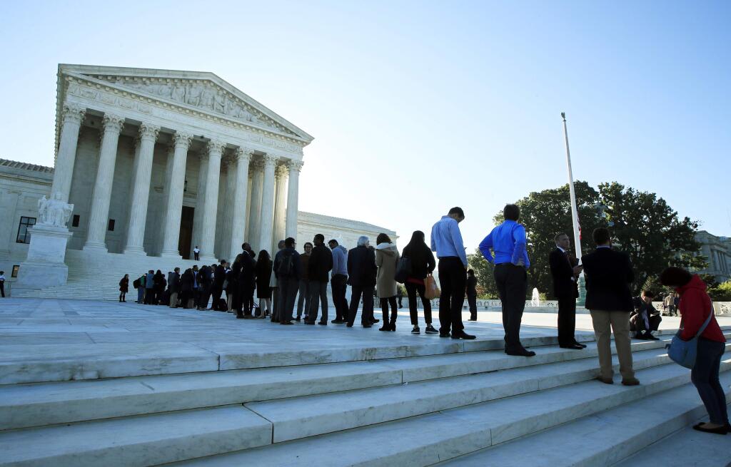 FILE - In this Oct. 3, 2017, file photo, people line up outside the U.S. Supreme Court in Washington to hear arguments in a case about political maps in Wisconsin that could affect elections across the country. The justices ruled against Wisconsin Democrats who challenged legislative districts that gave Republicans a huge edge in the state legislature. (AP Photo/Manuel Balce Ceneta, File)