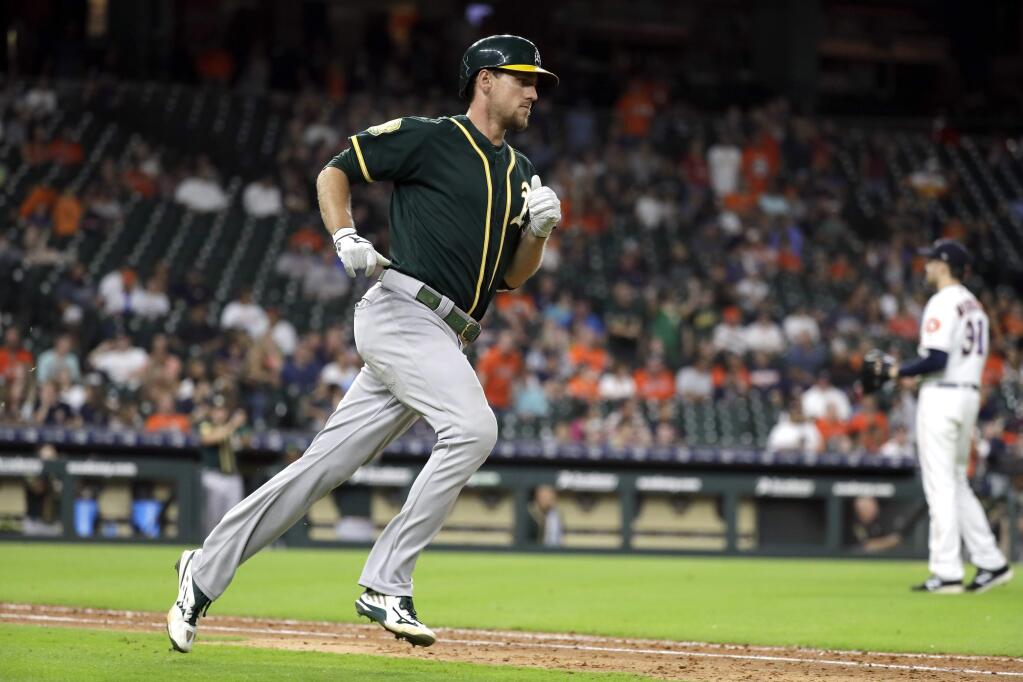 The Oakland Athletics' Stephen Piscotty, runs the bases after hitting a home run off Houston Astros relief pitcher Collin McHugh during the 11th inning Tuesday, July 10, 2018, in Houston. (AP Photo/David J. Phillip)