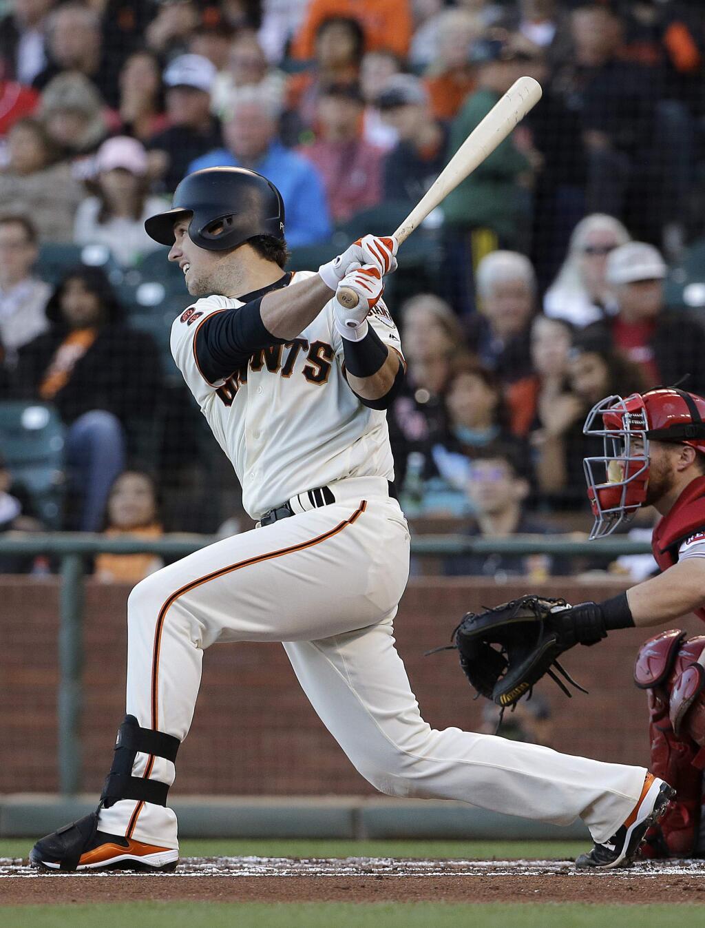 San Francisco Giants' Buster Posey hits an RBI-single against the Cincinnati Reds during the first inning of a baseball game in San Francisco, Monday, July 25, 2016. (AP Photo/Jeff Chiu)