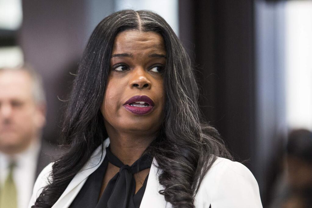 FILE- In this Feb. 23, 2019, file photo, Cook County State's Attorney Kim Foxx speaks to reporters at the Leighton Criminal Courthouse in Chicago. A grand jury revived criminal charges against Jussie Smollett on Tuesday, Feb. 11, 2020, just weeks before an election in which Foxx's opponents are using her handling of the Smollett case against her. (Ashlee Rezin/Chicago Sun-Times via AP, File)