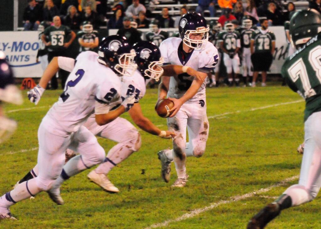 JONI KRIST/FOR THE ARGUS-COURIERPetaluma quarterback Brendan White (5) prepares to hand off to Yusef Kawasami (27) led by blocker Lucas Dentoni (2). A series of miscues led to a 14-5 Petaluma loss to Sonoma Valley.