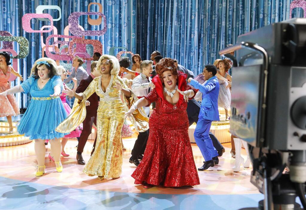 This image released by NBC shows, from left, Maddie Baillio as Tracy Turnblad, Jennifer Hudson as Motormouth Maybelle, Harvey Fierstein as Edna Turnblad during a rehearsal for 'Hairspray Live!,' airing Dec. 7. Sets for the musical were designed by Broadway set designer Derek McLane. (Trae Patton/NBC via AP)