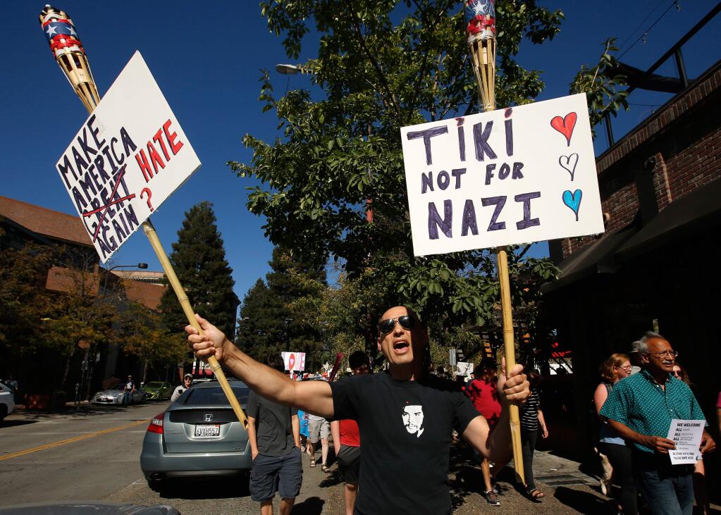 David Kersnar of Guerneville chants and carries signs during a demonstration in solidarity with the city of Charlottesville and protesting the racist rhetoric of the white nationalist movement, at Old Courthouse Square in Santa Rosa on Sunday, Aug. 13, 2017. (ALVIN JORNADA/ PD)