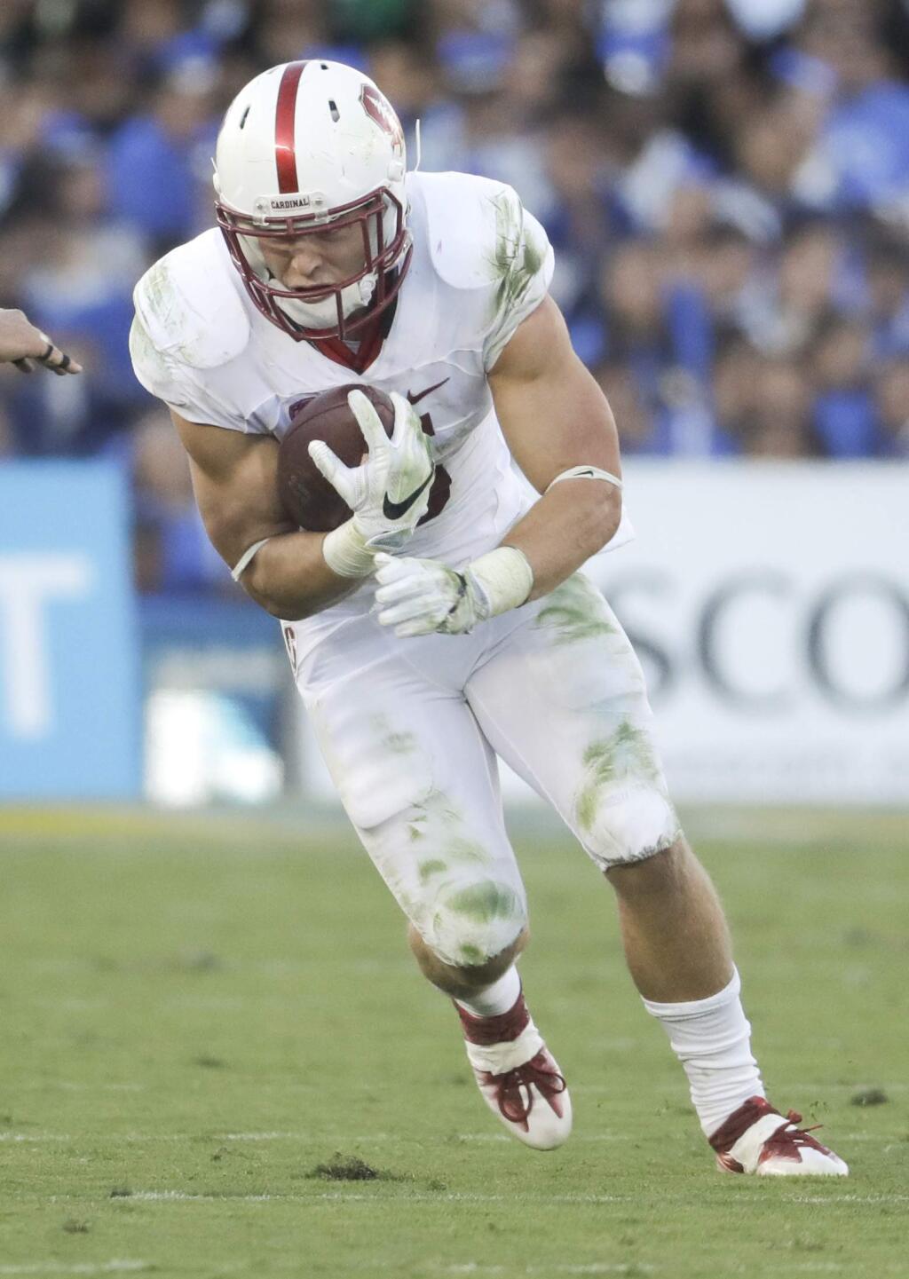 This Sept. 24, 2016 photo shows Stanford running back Christian McCaffrey running against UCLA during the first half in Pasadena. Stanford coach David Shaw said McCaffrey is feeling better and is hopeful that the 2015 Heisman Trophy finalist will be back in the lineup against Colorado on Saturday. (AP Photo/Chris Carlson, file)
