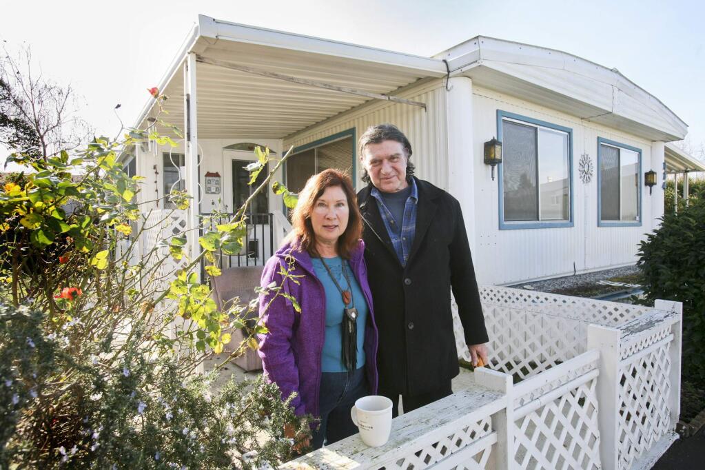 Michael and Irene Hansen in front of their home in Sandlewood senior mobilehome park in Petaluma on Tuesday, February 3, 2015. (SCOTT MANCHESTER/ARGUS-COURIER STAFF)