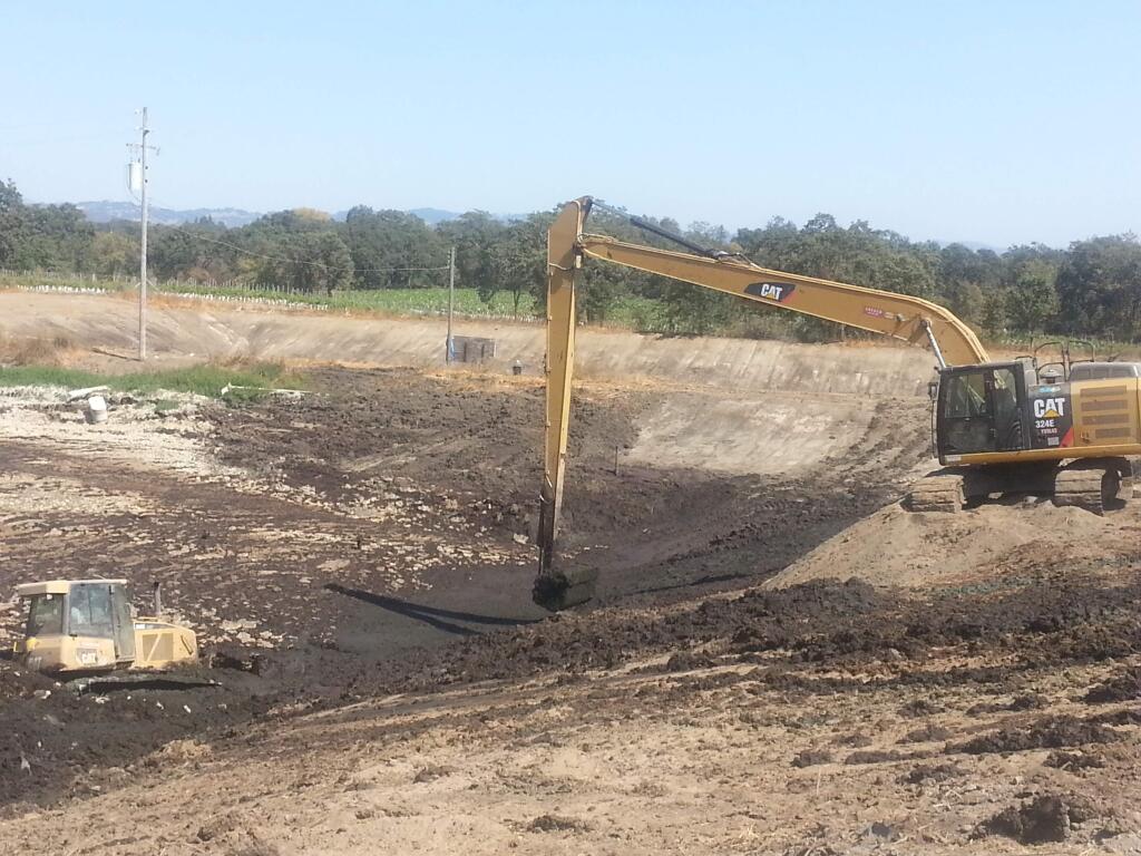 Excavators and bulldozers clear two massive lagoons of manure at the former site of the 177-acre Ocean View Dairy in northwest Santa Rosa in 2014. (KEVIN McCALLUM/ PD FILE)
