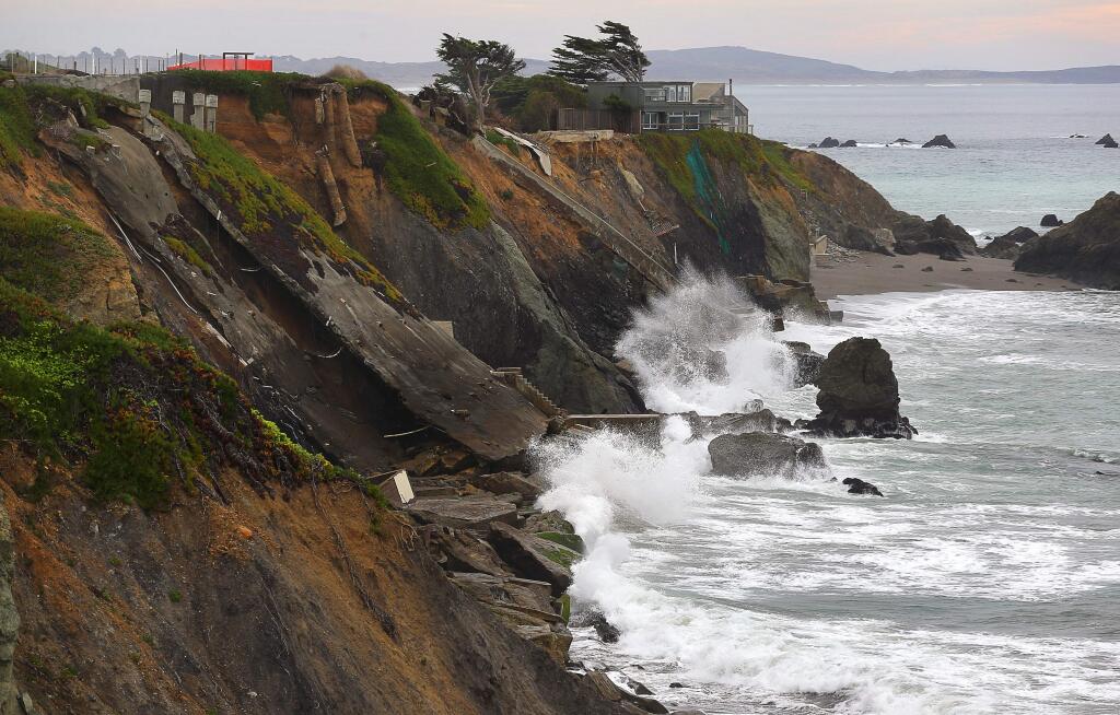 Waves crash on the remains of several homes that slid off of the eroding cliff, near Gleason Beach, north of Bodega Bay on Tuesday, January 2, 2018. (Christopher Chung/ The Press Democrat)