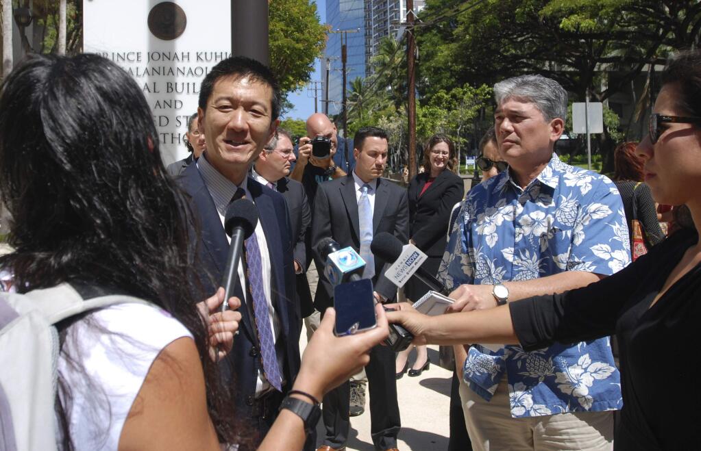 Hawaii Attorney General Douglas Chin speaks outside federal court in Honolulu, Wednesday, March 29, 2017. A federal judge in Hawaii questioned government attorneys Wednesday who urged him to narrow his order blocking President Donald Trump's travel ban because suspending the nation's refugee program has no effect on the state. U.S. District Judge Derrick Watson is hearing arguments on whether to extend his temporary order until Hawaii's lawsuit works its way through the courts. Even if he does not issue a longer-lasting hold on the ban, his temporary block would stay in place until he rules otherwise. (AP Photo/Caleb Jones)