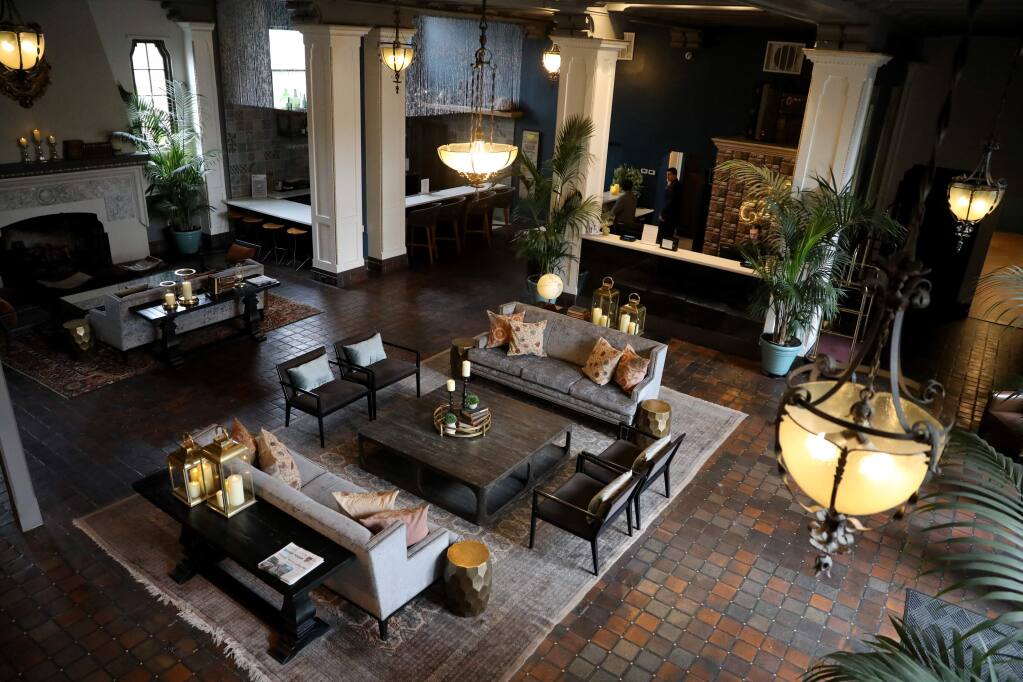 The lobby of the Hotel Petaluma is empty with the exception of front desk staff in Petaluma, California on Wednesday, March 18, 2020. (BETH SCHLANKER/The Press Democrat)
