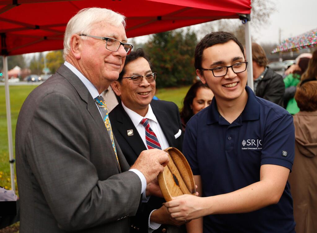 Rotary International president Ian Riseley, left, is presented with wooden bowl made from a piece of the original SRJC oak tree that was felled during a 2014 storm, by student trustee Robert Martinez, right, and SRJC president Dr. Frank Chong, at Santa Rosa Junior College, in Santa Rosa, California on Thursday, January 4, 2018. (Alvin Jornada / The Press Democrat)