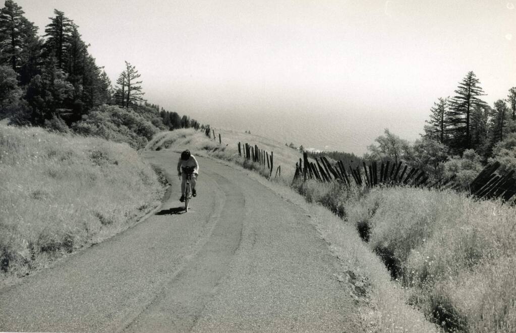 A lone cyclist navigates Coleman Valley Road, which connects Occidental to the sea. The road, one of the proposed 'Heritage Roads” in Sonoma County, is familiar to thousands of cyclists who have braved the long climb in Levi's GranFondo. (John LeBaron)