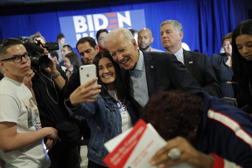 Former Vice President and Democratic presidential candidate Joe Biden poses for a selfie at a campaign event, Saturday, Nov. 16, 2019, in Las Vegas. (AP Photo/John Locher)