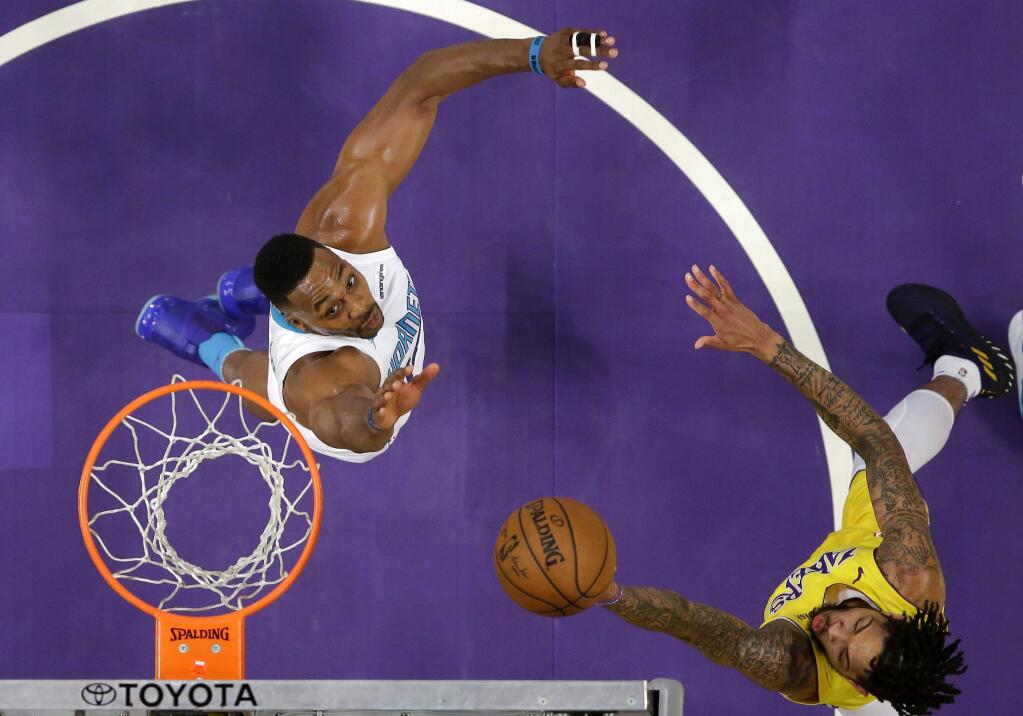 Los Angeles Lakers forward Brandon Ingram, right, shoots as Charlotte Hornets center Dwight Howard defends during the first half of an NBA basketball game Friday, Jan. 5, 2018, in Los Angeles. (AP Photo/Mark J. Terrill)