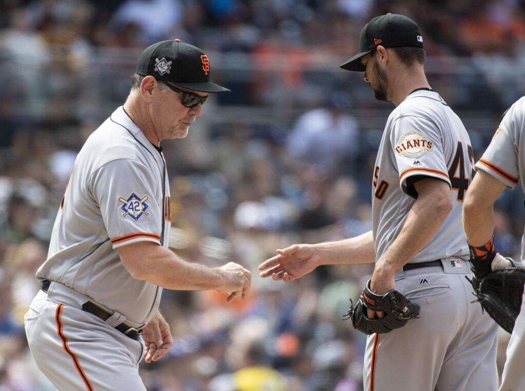 San Francisco Giants manager Bruce Bochy, left, removes starting pitcher Tyler Beede during the fourth inning against the San Diego Padres in San Diego, Sunday, April, 15, 2018. (AP Photo/Kyusung Gong)