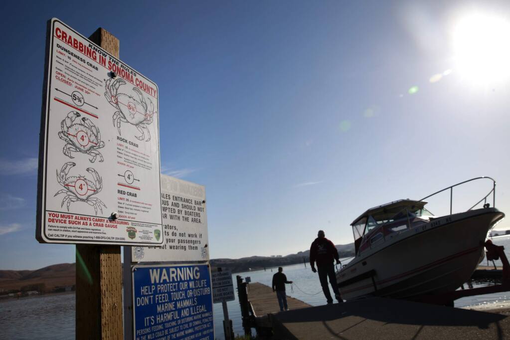 A sign alerts fisherman to the rules of crabbing at the boat ramp at Westside Regional Park in Bodega Bay in 2013. (MARY CALLAHAN/ PD FILE)