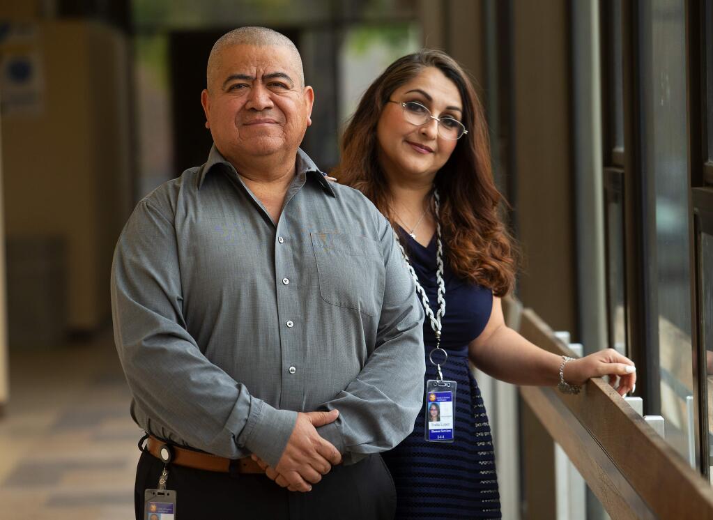 Ivette Lopez was so impressed when using the 211 help line she went to work for manager Bonifacio Torres, left, at Sonoma County Human Services. (photo by John Burgess/The Press Democrat)