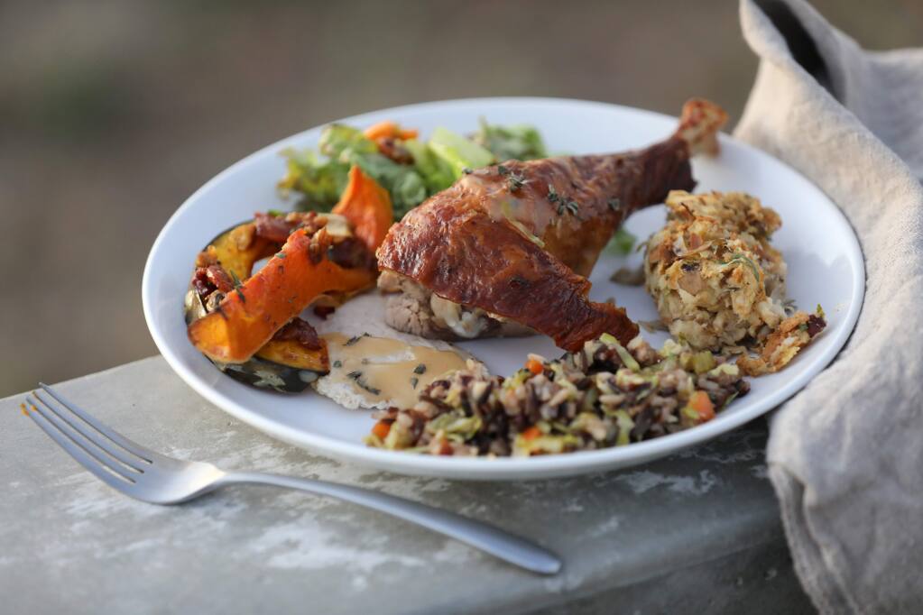 Photos by BETH SCHLANKER / The Press DemocratA roasted turkey leg is surrounded by (clockwise) a wild mushroom and hazelnut “stuffing,” rice and fall vegetable “stuffing,” squash with a maple bacon glaze, and fall harvest salad from a Thanksgiving cooking workshop at Wind & Rye Kitchen in Penngrove.