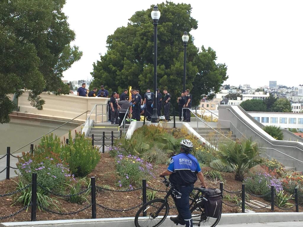 This Thursday, Aug. 3, 2017, photo courtesy of Antonia Juhasz shows San Francisco Police officers and paramedics at Dolores Park in San Francisco. Police say three people were shot at a popular San Francisco park. The San Francisco Police Department says people should stay away from Dolores Park, where the shooting happened Thursday afternoon. (Antonia Juhasz via AP)