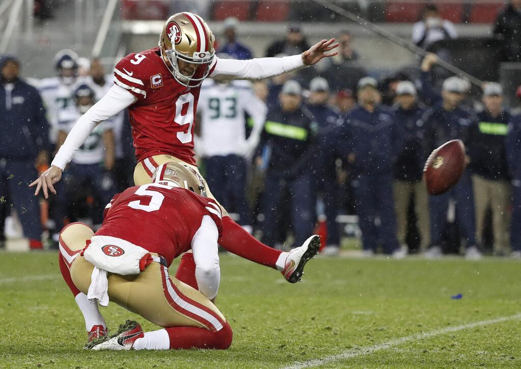 FILE - In this Dec. 16, 2018, file photo, San Francisco 49ers kicker Robbie Gould (9) kicks a field goal from the hold of Bradley Pinion during overtime of an NFL football game to defeat the Seattle Seahawks in Santa Clara, Calif. The 49ers have signed Gould to a four-year contract. The team had placed the franchise tag on Gould in February 2019 for a price tag of about $5 million before signing him to a long-term deal. (AP Photo/Tony Avelar, File)