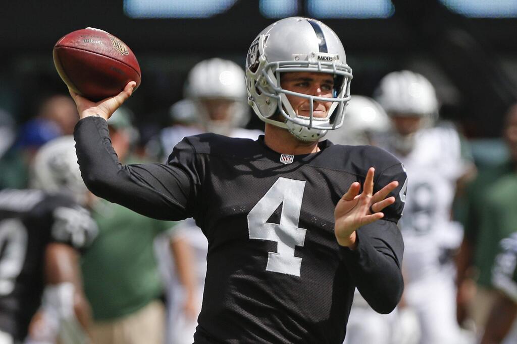 Oakland Raiders quarterback Derek Carr (4) throws a pass during the first half of an NFL football game against the New York Jets Sunday, Sept. 7, 2014, in East Rutherford, N.J. (AP Photo/Seth Wenig)