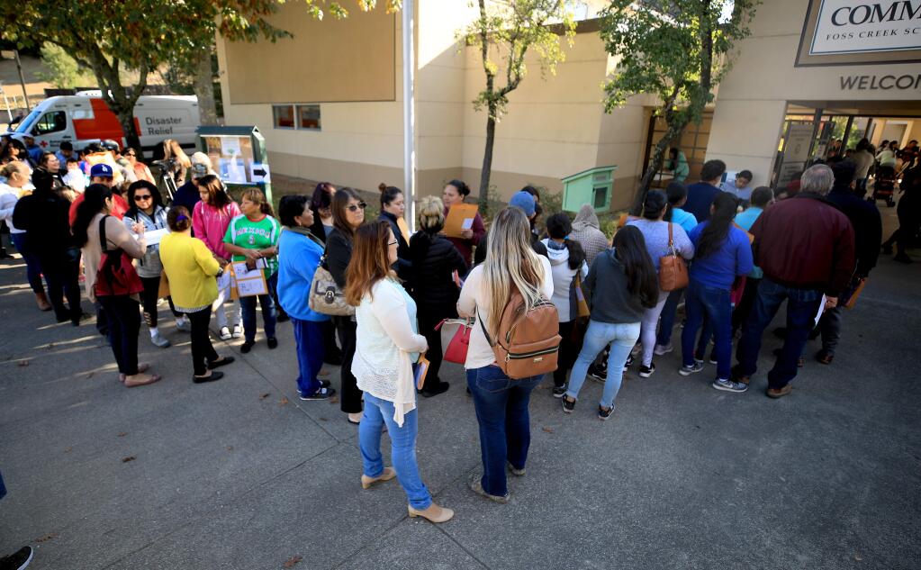 Victims of the Kincade fire line up at the Healdsburg Community Center to start the process of obtaining information of about the resources available to them to recoup losses, Monday, Nov. 5, 2019. (Kent Porter / The Press Democrat) 2019