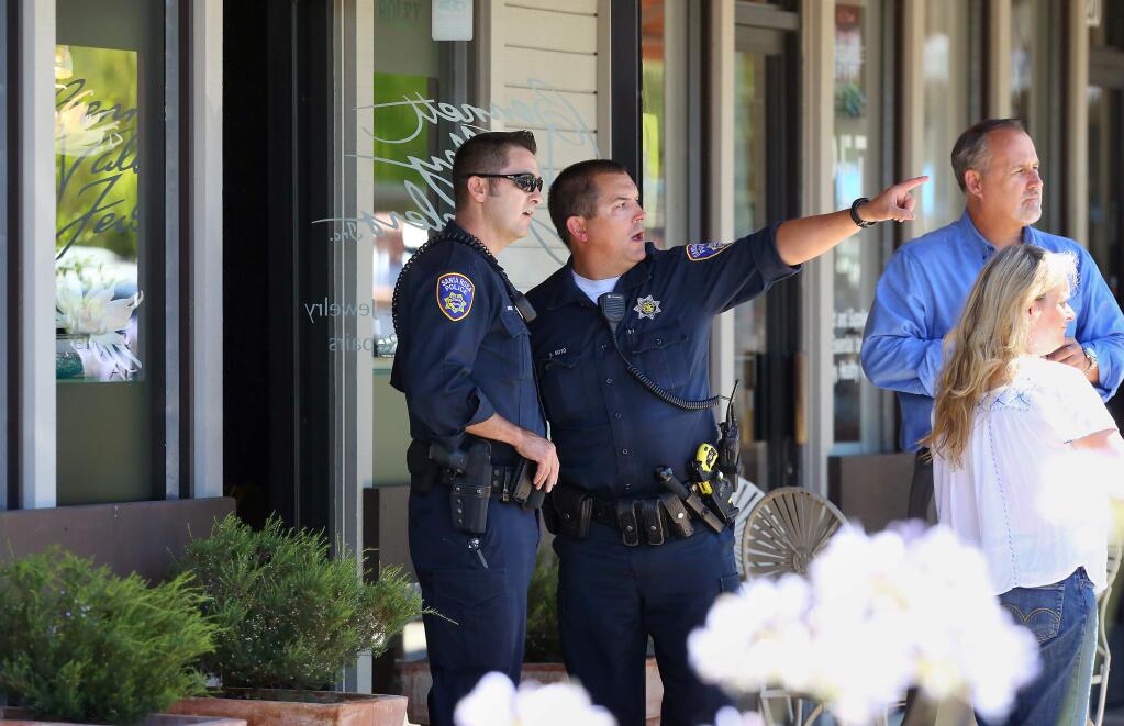 Santa Rosa Police investigate the scene of a robbery at Bennett Valley Jewelers in Santa Rosa on Thursday, July 10, 2014. (Christopher Chung/ The Press Democrat)