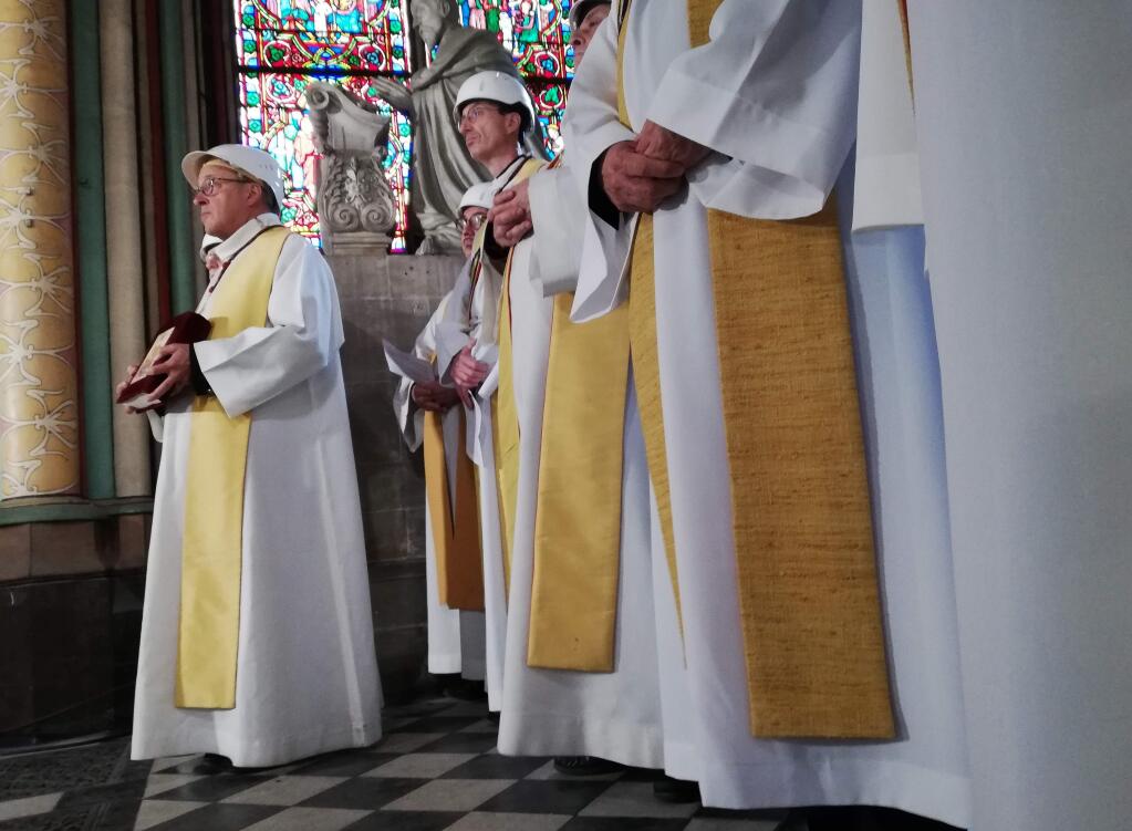 Priests attend a service led by Archbishop of Paris Michel Aupetit during the first mass in a side chapel, two months after a devastating fire engulfed the Notre-Dame de Paris cathedral, Saturday June 15, 2019, in Paris. (Karine Perret, Pool via AP)