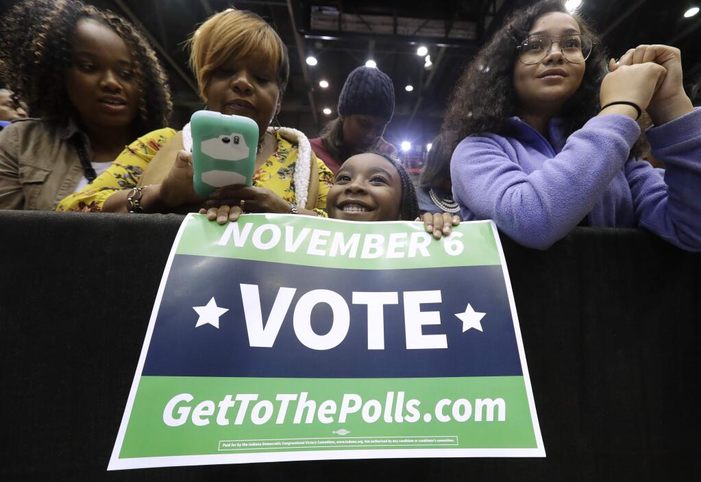 Supporters wait for former President Barack Obama during a rally to support Indiana Democratic congressional candidate U.S. Sen. Joe Donnelly at Genesis Convention Center in Gary, Ind., Sunday, Nov. 4, 2018. (AP Photo/Nam Y. Huh)