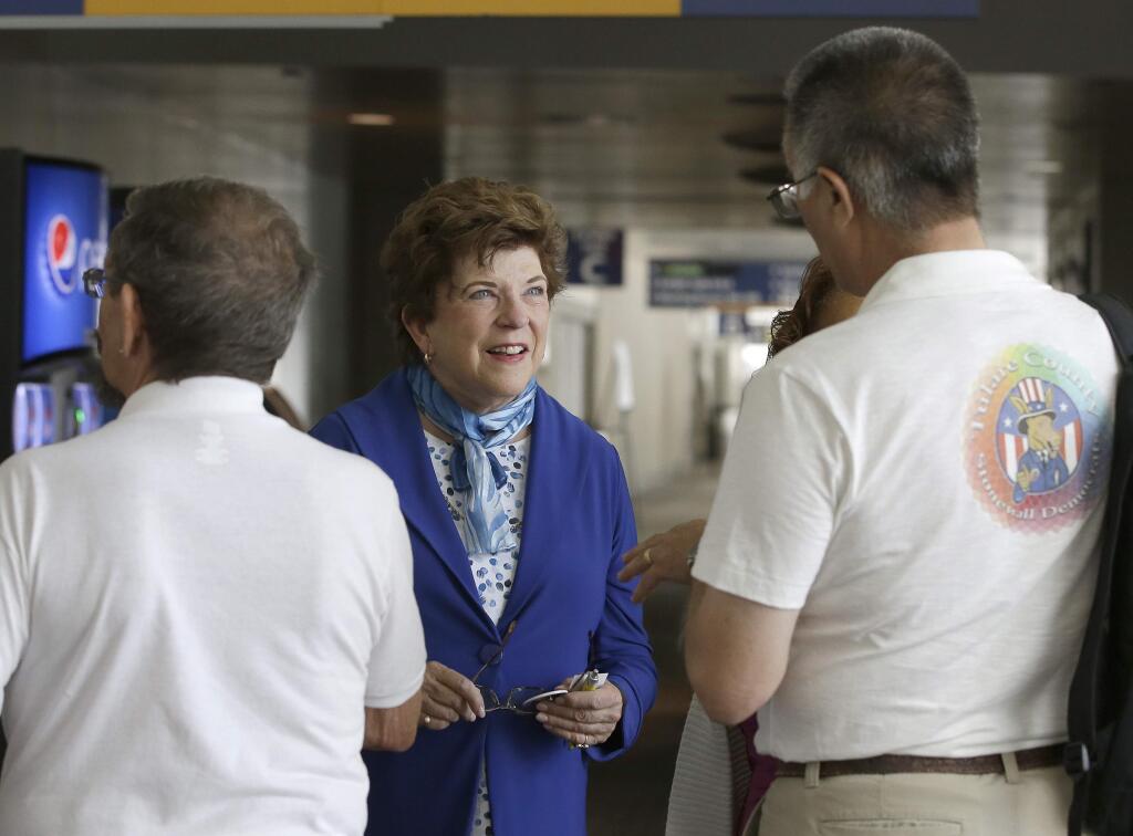 RETRANSMISSION TO CORRECT SPELLING OF NAME TO EASTIN - California gubernatorial candidate Delaine Eastin, the former state schools chief, talks with delegate Brock Neeley, right, of Porterville, at the California Democratic Party convention, Friday, May 19, 2017, in Sacramento, Calif. Thousands of California Democrats are gathering in the Capital city for the three-day convention that will see either Eric Bauman or Kimberley Ellis succeeding current party chairman John Burton. (AP Photo/Rich Pedroncelli)