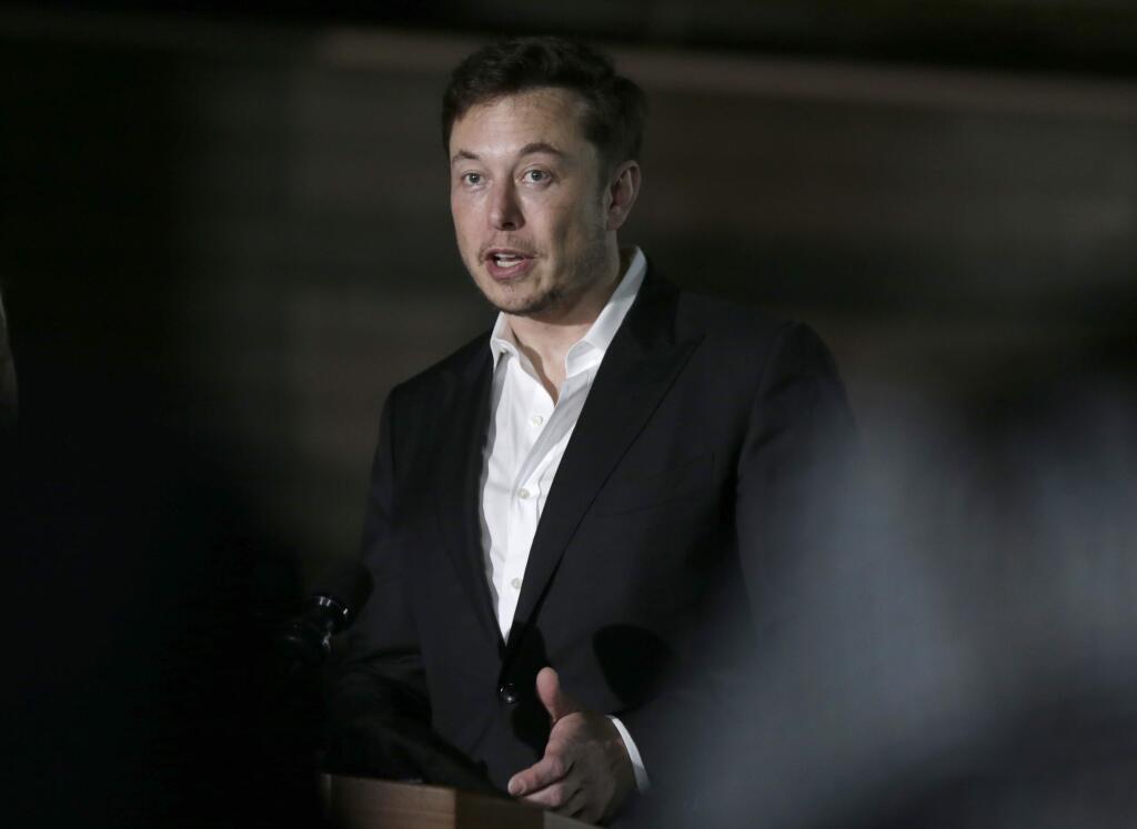FILE- In this June 14, 2018, file photo Tesla CEO and founder of the Boring Company Elon Musk speaks at a news conference in Chicago. Musk says he's in talks with the Saudi Arabian sovereign wealth fund about taking the electric car and solar panel maker private, but no deal has been finalized. Musk says in a blog posted Monday, Aug. 13, that most of the funding would be in stock rather than debt. (AP Photo/Kiichiro Sato, File)