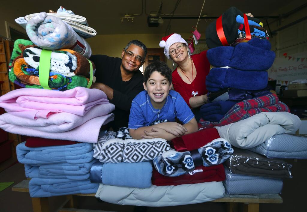 Ian Rich, 11, with the help of his father Josiah and mother Cary, started Operation Blanket to bring warm blankets to the needs during the holidays. (JOHN BURGESS / The Press Democrat)