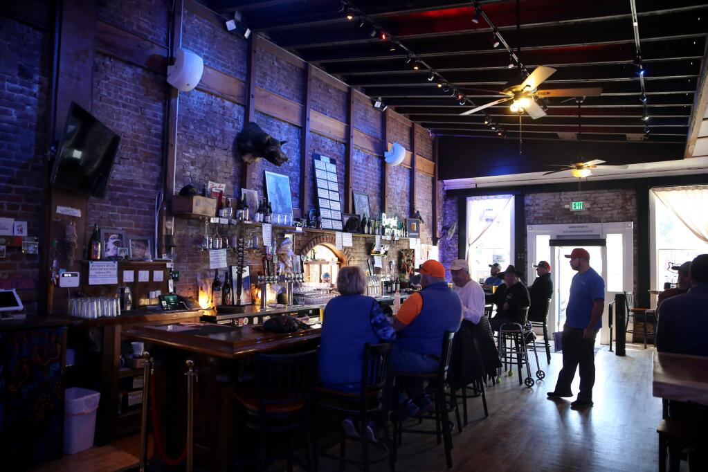 Patrons sit at the bar at the Hopland Tap in Hopland, California on Thursday, February 13, 2020. (BETH SCHLANKER/The Press Democrat)