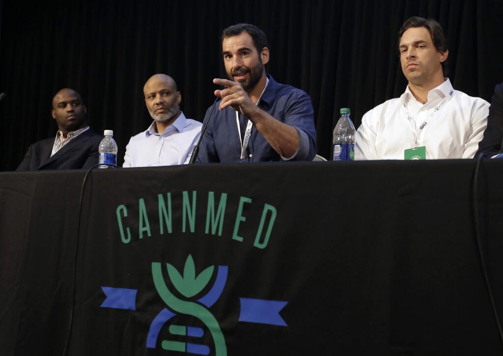 Former NFL players, from the left, Ricky Williams, Lance Johnstone, Nate Jackson and Eben Britton participate in a conference on medical marijuana at Harvard Medical School, Tuesday, April 11, 2017, in Boston. (AP Photo/Steven Senne)