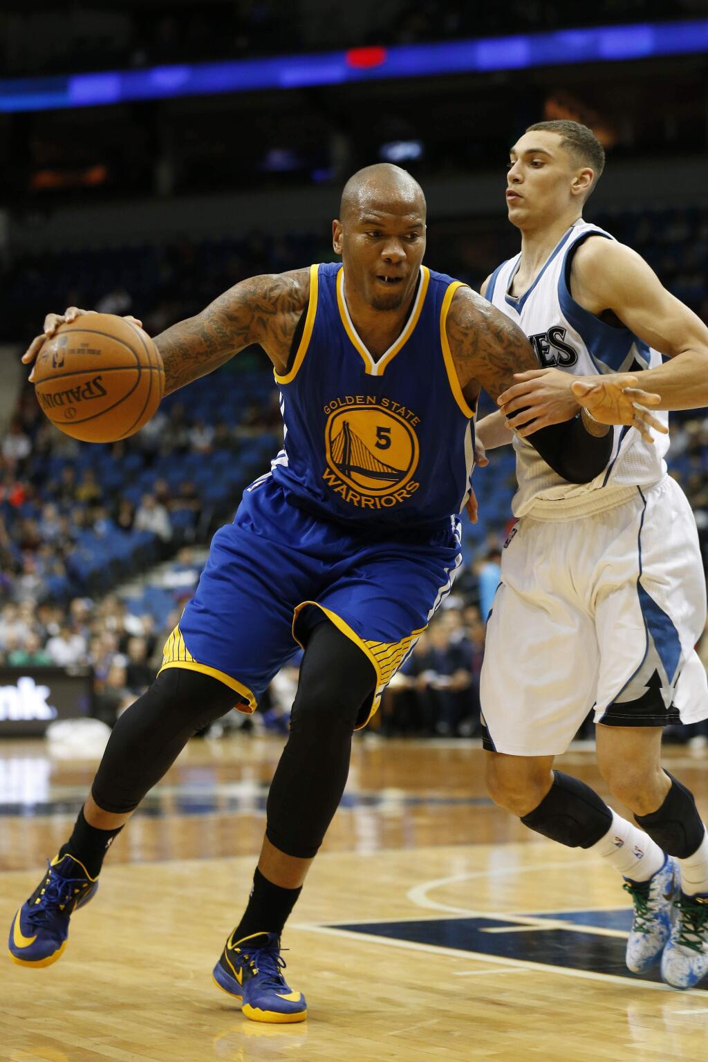 Golden State Warriors center Marreese Speights (5) pushes the ball around Minnesota Timberwolves guard Zach LaVine (8) during the second half of an NBA basketball game Monday, Dec, 8, 2014, in Minneapolis. The Warriors won 102-86. (AP Photo/Stacy Bengs)