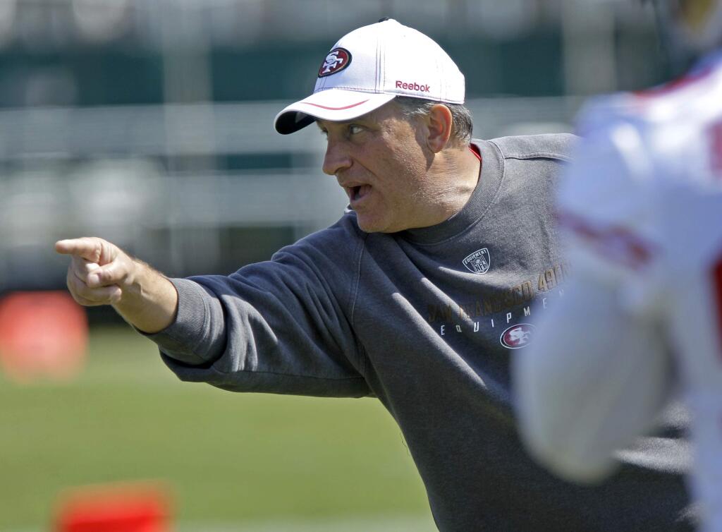 In this July 30, 2011, file photo, San Francisco 49ers defensive coordinator Vic Fangio gestures during training camp in Santa Clara. The former San Francisco 49ers defensive coordinator has taken the same job with the Chicago Bears under new coach John Fox. (AP Photo/Ben Margot, File)