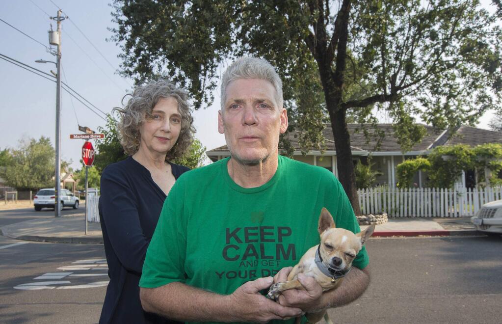 Nicole Katano and David Nogue (with Peanut), both own homes on the corner of 5th Street West and Mariano Drive. Rogue's house was in escrow until the buyers investigated the potential health hazards of the microwave radiation antennas that Verizon plans to install on the utility pole just next to his home. (Photo by Robbi Pengelly/Index-Tribune)