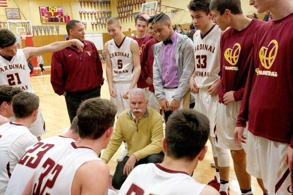 Cardinal Newman head coach Tom Bonfigli, center, talks to his players during a timeout in the second half of a boys varsity basketball game between Santa Rosa and Cardinal Newman high schools, in Santa Rosa on Friday, January 26, 2018. (Alvin Jornada / The Press Democrat)