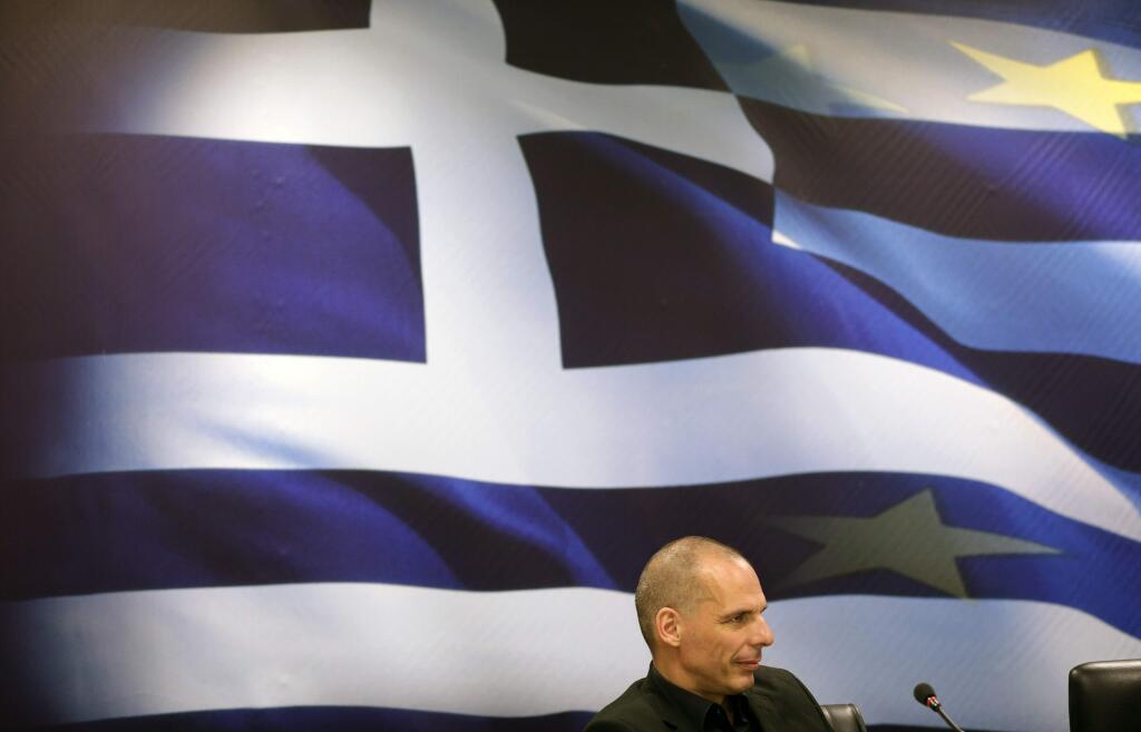 Outgoing Finance Minister Yanis Varoufakis attends the hand over ceremony with new Greek Finance Minister Euclid Tsakalotos, in Athens, Monday, July 6, 2015. Despite triumphing in a popular referendum vote against austerity, Greece on Monday faced the urgent need to heal its ties with European creditors and reach a financial rescue deal that might prevent it from falling out of the euro,(AP Photo/Petr David Josek)