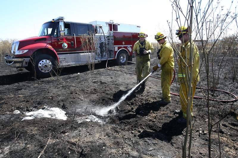 Schell-Vista firefighters Biran Galley, left, Kyle Simmons and Jeremy Branconi use water and hand tools to knock down hot spots in the aftermath of Sunday's fire in Sonoma, CA. (photo by John Burgess/The Press Democrat)