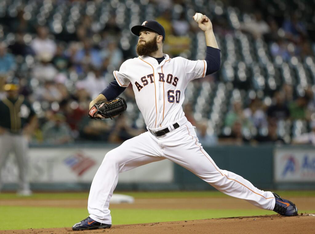 Houston Astros' Dallas Keuchel delivers a pitch against the Oakland Athletics in the first inning of a baseball game Tuesday, Aug. 26, 2014, in Houston. (AP Photo/Pat Sullivan)