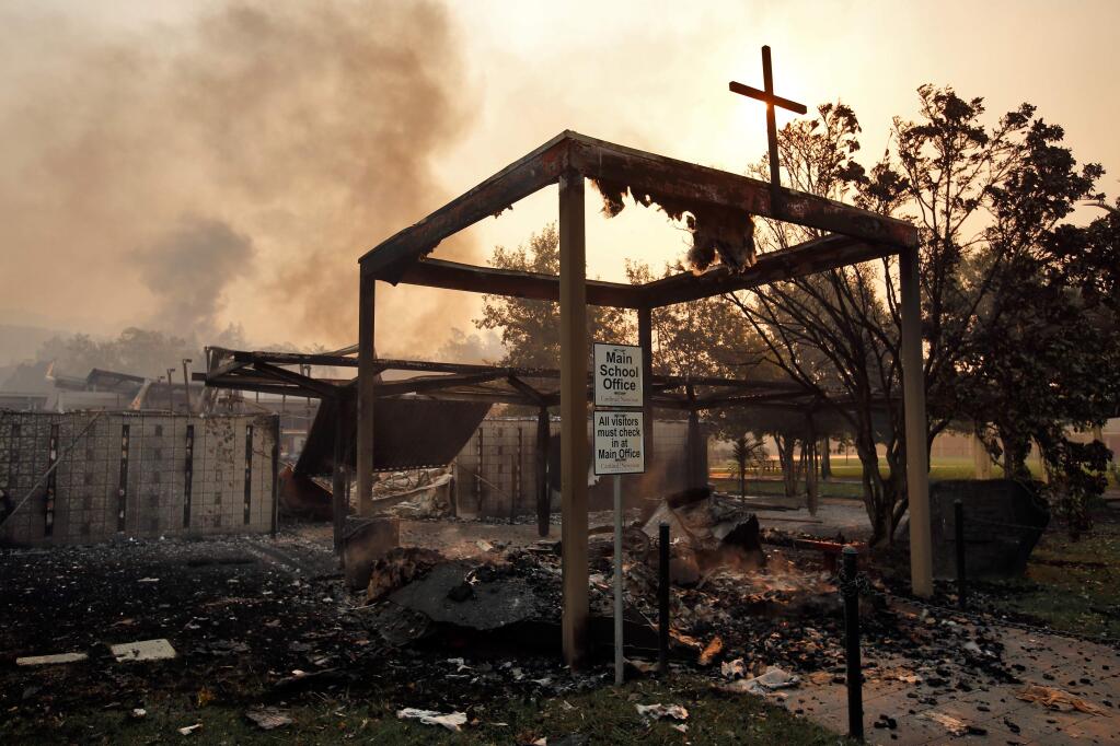 The Cardinal Newman High School main office smolders after the Tubbs fire burned through north Santa Rosa on Monday, Oct. 9, 2017. (ALVIN JORNADA/ PD)