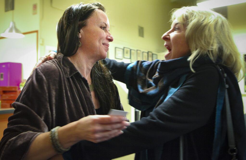 Deborah Dalton gets a hug from Jennifer Laporte, a founding member of Mentor Me after Deborah announced her replacement for executive director of Mentor Me to a crowd of stakeholders and donors. Deborah will continue to work part-time at Mentor Me and plans to attend graduate school.(CRISSY PASCUAL/ARGUS-COURIER STAFF)