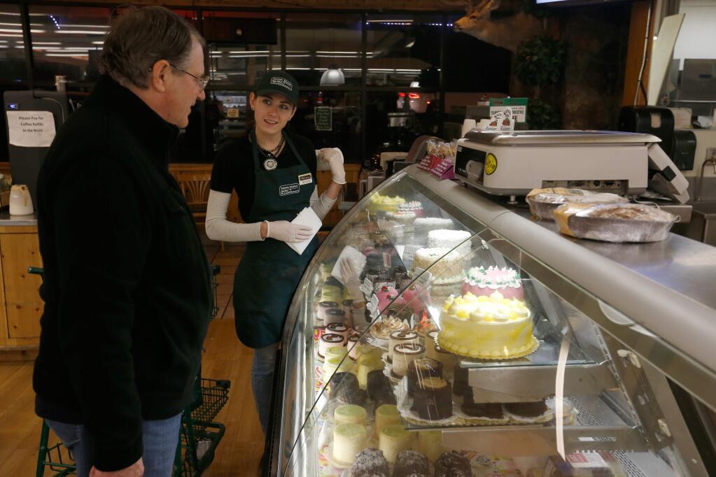 Customer Terry Crandall, left, asked deli worker Mercedes Dewitt advice on desserts at the Glen Ellen Village Market in Glen Ellen in 2016. File photo. (Alvin Jornada / The Press Democrat)